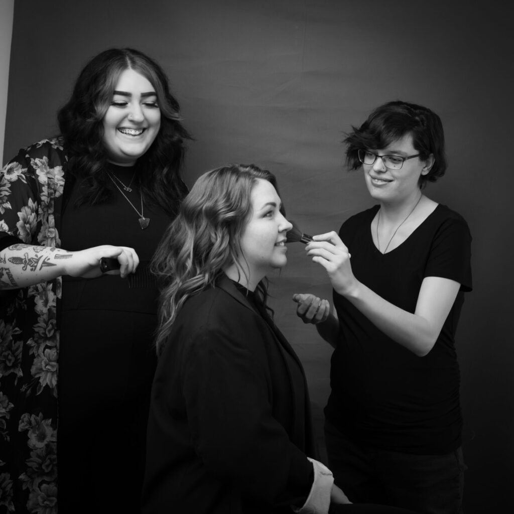 A woman gets her hair and makeup professionally styled